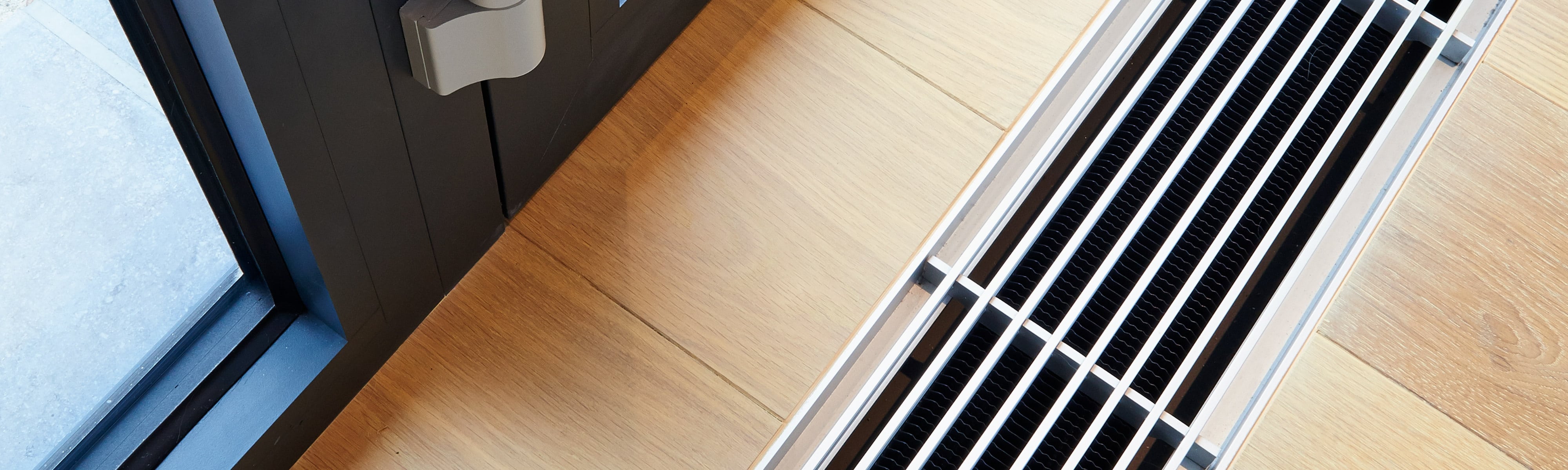 An air duct on a wooden floor.